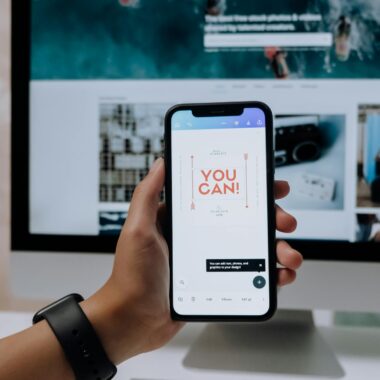 Holding a Smartphone in front of an Imac