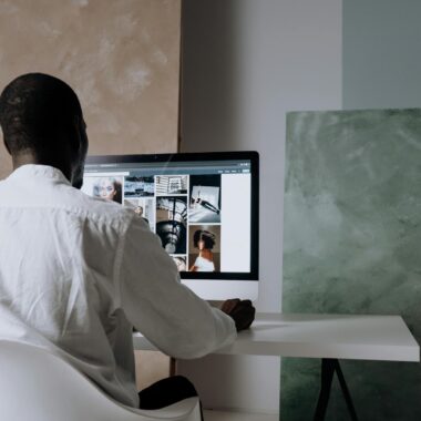 Man Browsing Pexels on an Imac